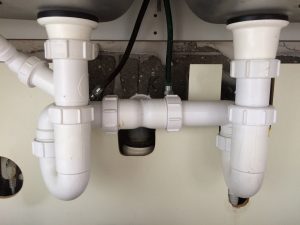 Unclogging a double kitchen sink drain