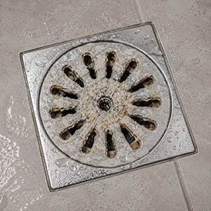 mineral deposits causing clogging issues over time in the shower drain